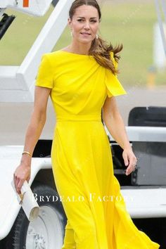 a woman in a yellow dress is walking