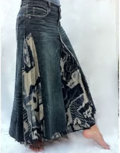 a woman is wearing a skirt made out of old jeans