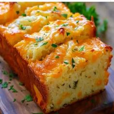 two slices of cheesy bread on a cutting board with parsley sprigs