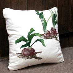 a decorative pillow with radishes on it