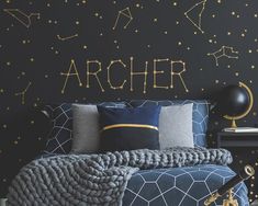 a bedroom with black walls and gold stars on the wall