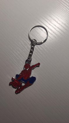 a spiderman keychain sitting on top of a table