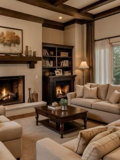 a living room filled with furniture and a fire place in the middle of a room