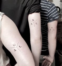 two people with matching tattoos on their arms