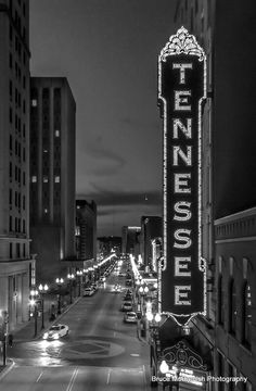 the tennessee theatre sign is lit up in black and white