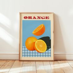 an orange poster is on the wall next to a wooden floor