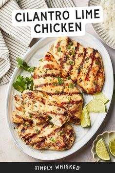 grilled chicken on a plate with limes and cilantro