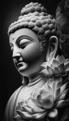 a black and white photo of a buddha statue with flowers on it's head