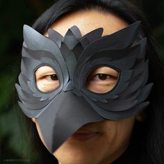 a woman wearing a mask made out of black paper