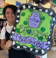 a woman holding up a sign in a store