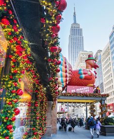 christmas decorations adorn the entrance to macy's in new york city