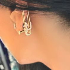 a close up of a person wearing ear clips with the word love on it's side