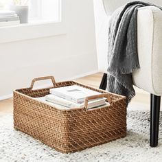 a wicker basket sitting on top of a rug next to a chair