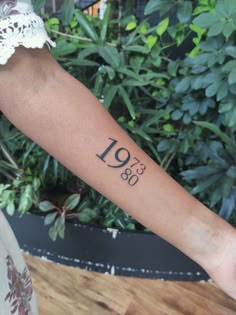 a woman's arm with the number nineteen on it