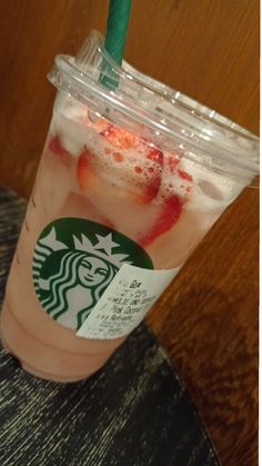 a starbucks drink with strawberries and ice