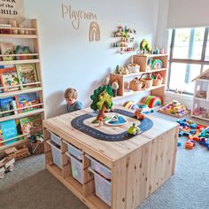 a child's playroom with toys and books on the shelves in front of it