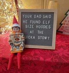 an elf is standing next to a sign that says your dad said he found elf hoodies at the licka stow?