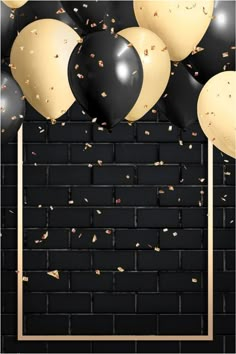 black and gold balloons are in front of a brick wall