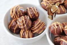 three bowls filled with chocolate candy covered in caramel drizzle