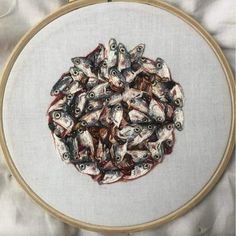 a bunch of fish that are in some kind of embroidery on a piece of cloth