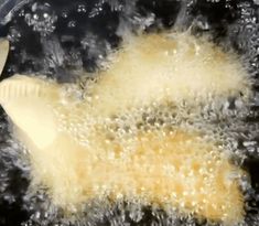 an image of food being cooked in a pan with water and oil on the side