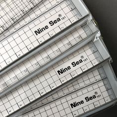 four rulers are stacked on top of each other with the words mine sea printed on them