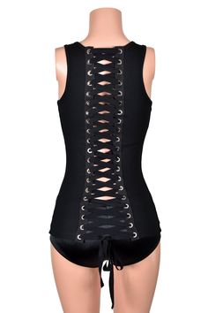 *Free USA shipping! *Handmade after you order: check order processing times This extra long black tank top has many rows of jumbo grommets and black elastic corset lacing going down the back. It has a square scoop neck and racer back. Note: the mannequin is wearing the top over Low Rise Satin Booty Shorts. The shorts are sold separately and are not attached to the top. ♦LENGTH: about 26-28 inches total (depending on size) ♦FABRIC TYPE: 52% cotton, 48% polyester micro rib knit♦FEATURES: silver me Fitted Tank Top For Club, Punk Sleeveless Corset For Festivals, Punk Style Sleeveless Corset For Festivals, Edgy Corset With Corset Back For Alternative Fashion, Edgy Fitted Corset With Straps, Edgy Fitted Vest For Festivals, Black Stretch Corset With Straps, Fitted Festival Tops With Tank Straps, Black Lace-up Back Corset For Night Out