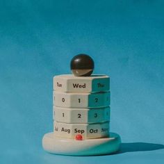 a stack of stacked ceramic items on top of each other in front of a blue background