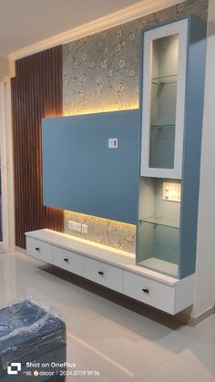 a modern living room with blue walls and white furniture in the center, lighted by recessed lighting