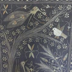 an embroidered cloth with birds and flowers on it