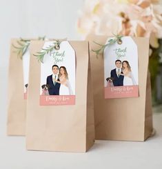 two brown paper bags with wedding pictures on them