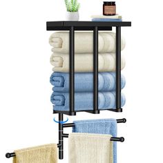 a towel rack with towels on it next to a potted plant