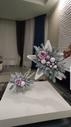 someone is arranging flowers on top of a box