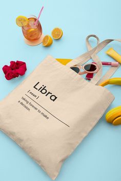 a tote bag sitting on top of a table next to some scissors and lemons