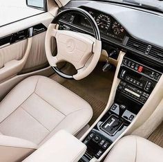 the interior of a car with beige leather seats and steering wheel, dashboard controls and dash board