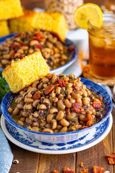 a bowl filled with beans and corn on top of a table next to other foods