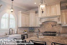 a kitchen with white cabinets and marble counter tops