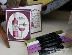 some wine bottles are sitting on a table next to two greeting cards and a bottle of wine