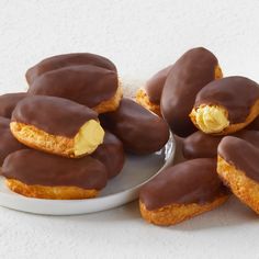 chocolate covered donuts on a white plate