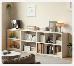 a living room filled with furniture and bookshelves next to a coffee table on top of a rug