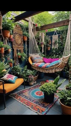 an outdoor patio with plants and hammock hanging from it's roof, surrounded by potted plants