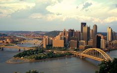 an aerial view of a city and bridge