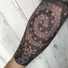 a man's arm with an intricate tattoo design on the left side of his arm