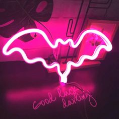 a neon sign that is on top of a table