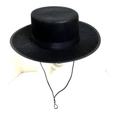 Zorro Classic Black Spanish Hat Zorro’s Hat Is A Signature Part Of His Look Complete Your Costume With Classic Hat Great For Many Costumes Spanish - Gaucho - Amish - Flat Top - Cinco De Mayo - Costume Hats Hat Comes With Chin Ties Black Satin Ribbon Hat Band 100% Polyester One Size Fits Most 23“ Diameter Flat - Wide Brim - 2 ¾” Crown 3.5” Black Boater Hat With Short Brim For Rodeo, Black Boater Hat For Rodeo With Short Brim, Black High Crown Felt Hat With Adjustable Fit, Black High Crown Fedora For Winter, Black Top Hat With Flat Brim, Black Wide Brim Costume Hat For Winter, Black Wide Brim Costume Hat, Adjustable Black High Crown Boater Hat, Black Brimmed Mini Hats For Rodeo