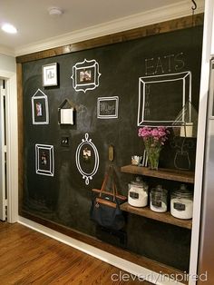 a chalkboard with pictures and frames on it