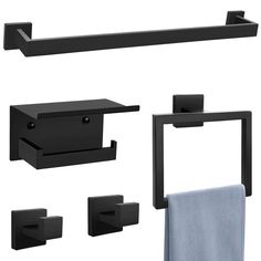 black bathroom accessories including towel, soap dispenser, and toilet paper holder