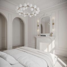 a white bedroom with a fireplace, mirror and bed