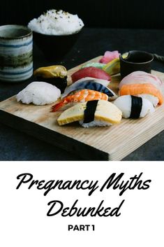 a wooden cutting board topped with different types of sushi on top of each other