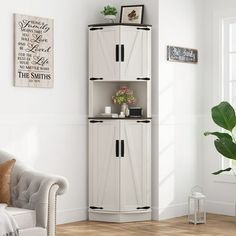 a living room with a white couch and wooden shelves on the wall next to a potted plant